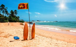 Surfbrett und Flagge von Sri Lanka am Strand